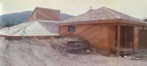 Exterior of the Colosol earth-sheltered house. The structure's garage and air-lock entryway are located above ground. The living area is set partially below ground.